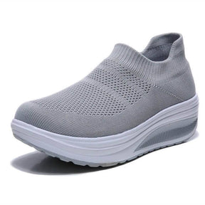 Grey casual women's sneakers with knit upper and thick white sole, perfect for daily comfort and style.